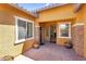 Inviting front porch with stylish brickwork, decorative plants, and a welcoming entryway at 19291 E Thornton Rd, Queen Creek, AZ 85142