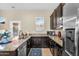 Kitchen features granite counters, stainless steel appliances, and wood cabinets with a window at 19291 E Thornton Rd, Queen Creek, AZ 85142