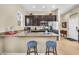 Kitchen features granite countertops, stainless steel appliances and a breakfast bar with seating at 19291 E Thornton Rd, Queen Creek, AZ 85142
