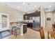 Open-concept kitchen features granite countertops, stainless steel appliances, and a cozy breakfast bar at 19291 E Thornton Rd, Queen Creek, AZ 85142