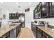 A gourmet kitchen features stainless steel appliances, granite countertops, and ample storage space at 19291 E Thornton Rd, Queen Creek, AZ 85142