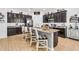 Elegant kitchen island featuring granite countertops, dark wood cabinets, and bar stool seating at 19291 E Thornton Rd, Queen Creek, AZ 85142