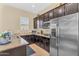 Kitchen features granite counters, stainless steel appliances, and dark cabinetry at 19291 E Thornton Rd, Queen Creek, AZ 85142