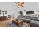 Spacious living room offering a comfortable sectional sofa and an open concept design at 19291 E Thornton Rd, Queen Creek, AZ 85142