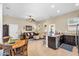 Open concept living room and kitchen with granite counters, stainless appliances, and casual dining area at 19291 E Thornton Rd, Queen Creek, AZ 85142