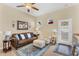 Cozy living room with plush seating, decorative accents, and ample natural light from the windows at 19291 E Thornton Rd, Queen Creek, AZ 85142