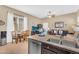 Bright and open living space showcasing a kitchen with granite counters and dining area at 19291 E Thornton Rd, Queen Creek, AZ 85142