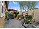 Inviting backyard patio with built-in BBQ, swing, table/chairs, lush greenery, and flowers at 19291 E Thornton Rd, Queen Creek, AZ 85142
