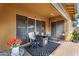 Comfortable covered patio features modern furniture, ceiling fans and a decorative area rug at 19291 E Thornton Rd, Queen Creek, AZ 85142