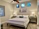 Comfortable bedroom with a ceiling fan, three windows for plenty of light and a neutral color palette at 2042 W Periwinkle Way, Chandler, AZ 85248