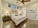 Comfortable bedroom with a ceiling fan, three windows for plenty of light and a neutral color palette at 2042 W Periwinkle Way, Chandler, AZ 85248