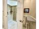 Walk-in closet featuring built-in shelving, marble floors, and an ironing station at 2042 W Periwinkle Way, Chandler, AZ 85248