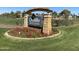 Ocotillo Golf Club sign surrounded by lush landscaping and red flowers, indicating the entrance to the community at 2042 W Periwinkle Way, Chandler, AZ 85248