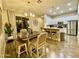 Dining area with modern chandelier, access to the kitchen, and sliding glass doors to outdoor space at 2042 W Periwinkle Way, Chandler, AZ 85248