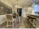 Dining area with modern chandelier, access to the kitchen, and sliding glass doors to outdoor space at 2042 W Periwinkle Way, Chandler, AZ 85248