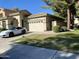Beautiful single-Gathering home with a two-car garage, lush lawn, mature trees and a white luxury car in the driveway at 2042 W Periwinkle Way, Chandler, AZ 85248