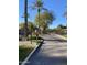 Gated entrance to a well-maintained community featuring lush landscaping, mature trees, and block paved entrance at 2042 W Periwinkle Way, Chandler, AZ 85248