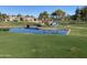 Picturesque golf course view with water features, mature trees, and a bridge, showing a peaceful recreational setting at 2042 W Periwinkle Way, Chandler, AZ 85248