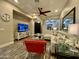 Elegant living room featuring wood-look tile flooring, a modern ceiling fan, and stylish decor at 2042 W Periwinkle Way, Chandler, AZ 85248