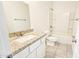 Bathroom features granite countertops, a single sink vanity and a shower over tub at 20435 W Mountain Sage Dr, Buckeye, AZ 85326