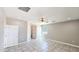 Spacious bedroom boasts neutral walls, tile floors, ceiling fan and ample natural light at 20435 W Mountain Sage Dr, Buckeye, AZ 85326