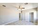 Spacious bedroom with tile flooring, ceiling fan, and closet at 20435 W Mountain Sage Dr, Buckeye, AZ 85326