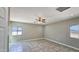 A bright bedroom features neutral walls, tile flooring, and a ceiling fan for added comfort at 20435 W Mountain Sage Dr, Buckeye, AZ 85326