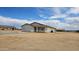 Lovely single-story home with a neutral stucco exterior and an attached two-car garage in a desert setting at 20435 W Mountain Sage Dr, Buckeye, AZ 85326