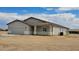 Spacious one-story home with a two-car garage, stucco exterior, and a covered porch, set in a desert environment at 20435 W Mountain Sage Dr, Buckeye, AZ 85326