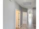 Inviting hallway with neutral tones, tiled floors, and multiple doorways leading to rooms at 20435 W Mountain Sage Dr, Buckeye, AZ 85326