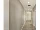 Inviting hallway with tile flooring, recessed lighting and neutral-toned walls leading to various rooms at 20435 W Mountain Sage Dr, Buckeye, AZ 85326