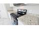 Modern kitchen featuring granite countertops and stainless steel appliances at 20435 W Mountain Sage Dr, Buckeye, AZ 85326
