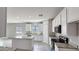 The open kitchen features white cabinets and granite countertops, seamlessly connecting to the living space at 20435 W Mountain Sage Dr, Buckeye, AZ 85326