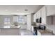 This kitchen features white cabinets, granite countertops, stainless steel appliances, and an island at 20435 W Mountain Sage Dr, Buckeye, AZ 85326