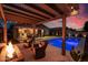 Backyard with pool, putting green, fire pit, and ample space for outdoor activities and entertaining at 22262 E Cherrywood Ct, Queen Creek, AZ 85142