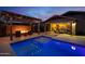 Backyard with pool, putting green, fire pit, and ample space for outdoor activities and entertaining at 22262 E Cherrywood Ct, Queen Creek, AZ 85142