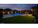 Backyard with pool, putting green, fire pit, and ample space for outdoor activities and entertaining at 22262 E Cherrywood Ct, Queen Creek, AZ 85142