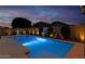 Backyard with pool, putting green, fire pit, and ample space for outdoor activities and entertaining at 22262 E Cherrywood Ct, Queen Creek, AZ 85142