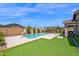 Resort-style backyard with pool, putting green, and patio area; perfect for entertaining at 22262 E Cherrywood Ct, Queen Creek, AZ 85142