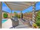 Inviting backyard patio with pergola offering shade for outdoor seating and lounging at 22262 E Cherrywood Ct, Queen Creek, AZ 85142