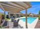 Beautiful backyard pool with pergola, lounge seating and inviting patio at 22262 E Cherrywood Ct, Queen Creek, AZ 85142