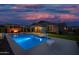 Backyard with pool, putting green, fire pit, and ample space for outdoor activities and entertaining at 22262 E Cherrywood Ct, Queen Creek, AZ 85142