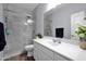 Bathroom with white cabinets, a marble tile shower, and tile flooring at 22262 E Cherrywood Ct, Queen Creek, AZ 85142