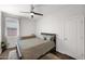 Neutral bedroom with wood dresser, patterned bedding, and a ceiling fan at 22262 E Cherrywood Ct, Queen Creek, AZ 85142
