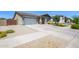 Front exterior view of a single-story home with well-kept lawn and a two-car garage at 22262 E Cherrywood Ct, Queen Creek, AZ 85142