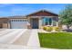 Beautiful single-story home with well-maintained lawn, desert landscaping, and a two car garage at 22262 E Cherrywood Ct, Queen Creek, AZ 85142
