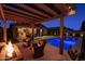 Relaxing outdoor space with a firepit, pool, and patio seating at 22262 E Cherrywood Ct, Queen Creek, AZ 85142