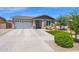 Single-story home featuring a two car garage and neatly landscaped front yard at 22262 E Cherrywood Ct, Queen Creek, AZ 85142