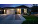 Charming single-story home featuring a two-car garage, manicured lawn, and inviting entryway at 22262 E Cherrywood Ct, Queen Creek, AZ 85142