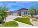 Charming single-story home with a well-maintained front yard featuring green grass and a decorative walkway at 22262 E Cherrywood Ct, Queen Creek, AZ 85142